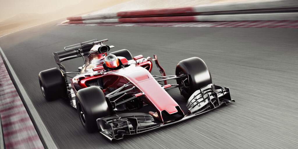 Racecar driving at speed around a course