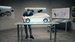 Automotive designer working on prototype model car