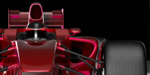 3D render of a red racing automotive vehicle against a black background.