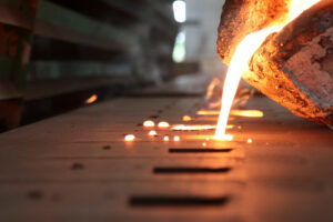 Close up of molten metal being poured into a mold