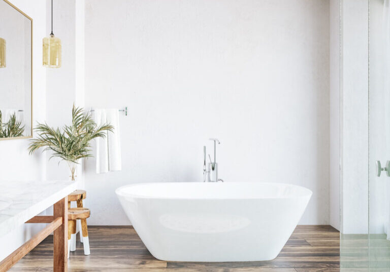 3D render of a new white bathroom with a bath as the focal point