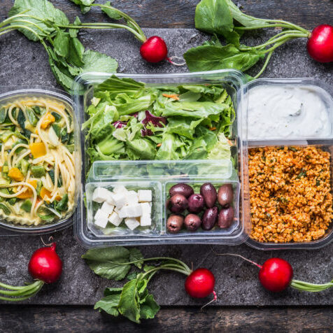 Variety of foods shown packaged in clear plastic thermoformed containers