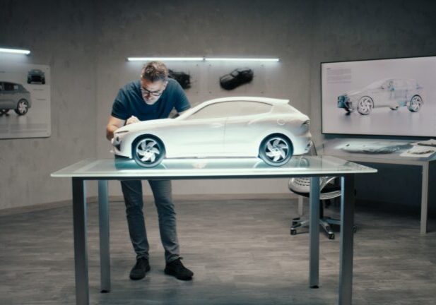 Automotive designer working on prototype model car