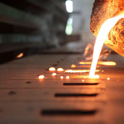 Close up of molten metal being poured into a mold