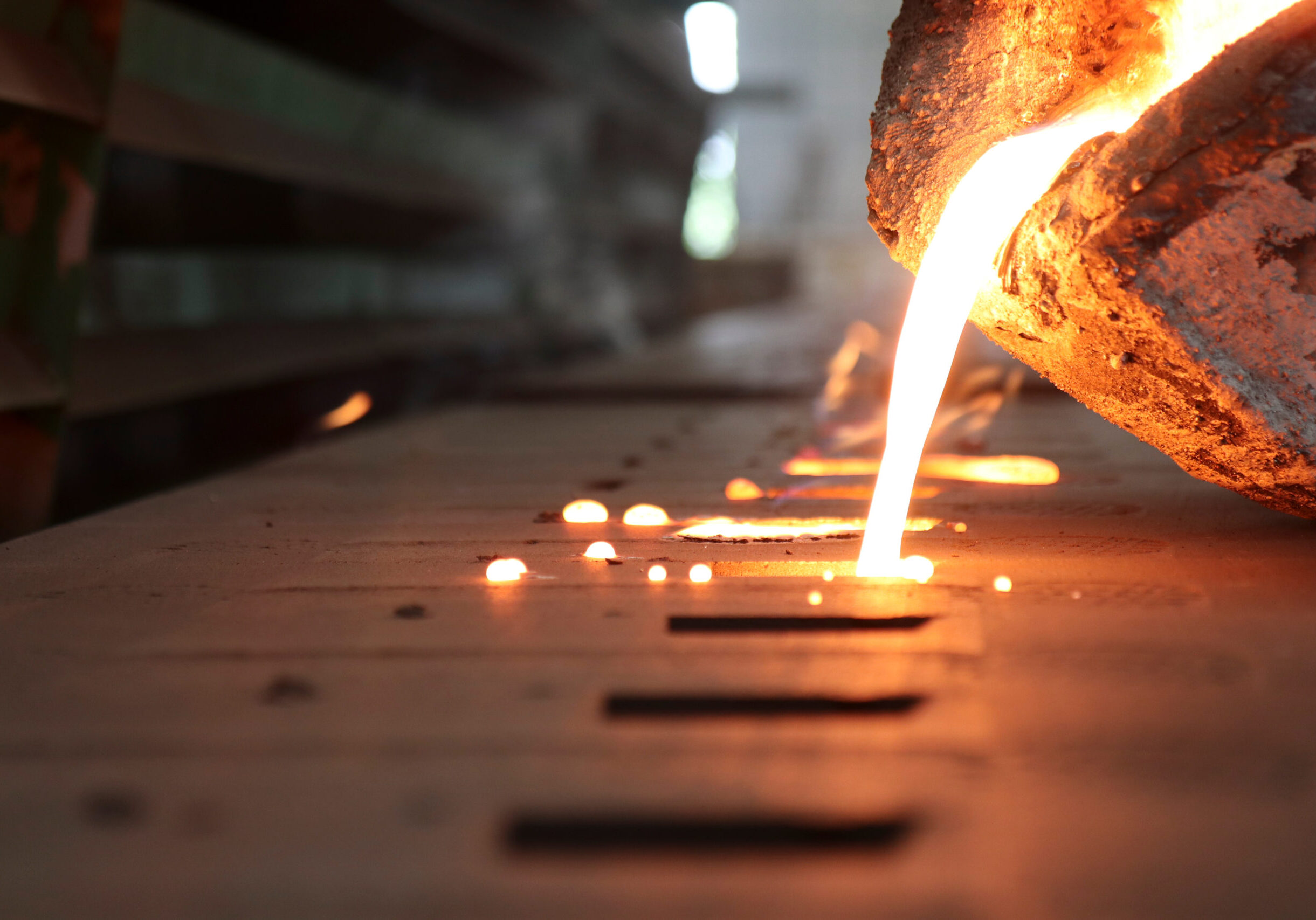 Close up of molten metal being poured into a mold