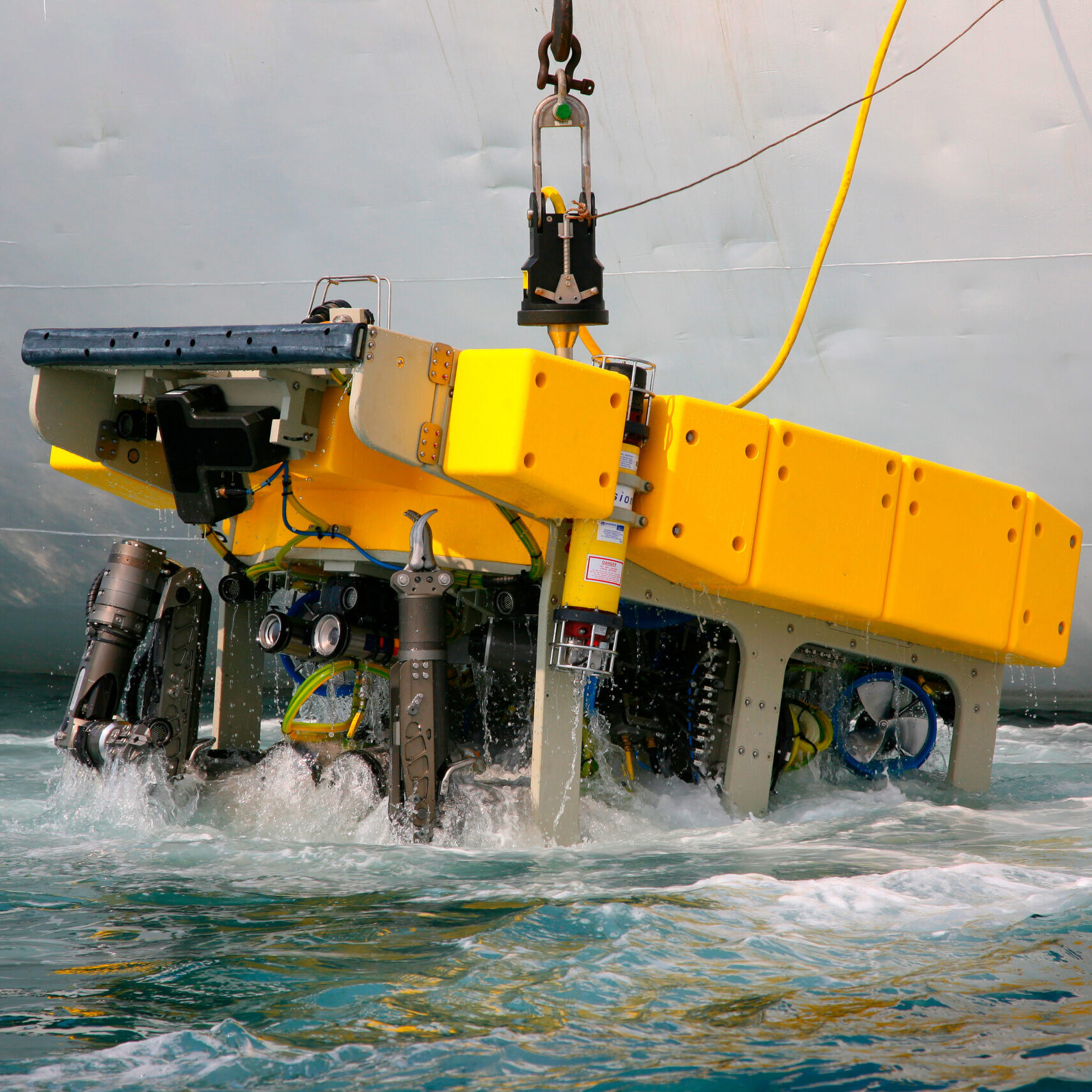 Remotely operated underwater vehicle being lifted out of the water