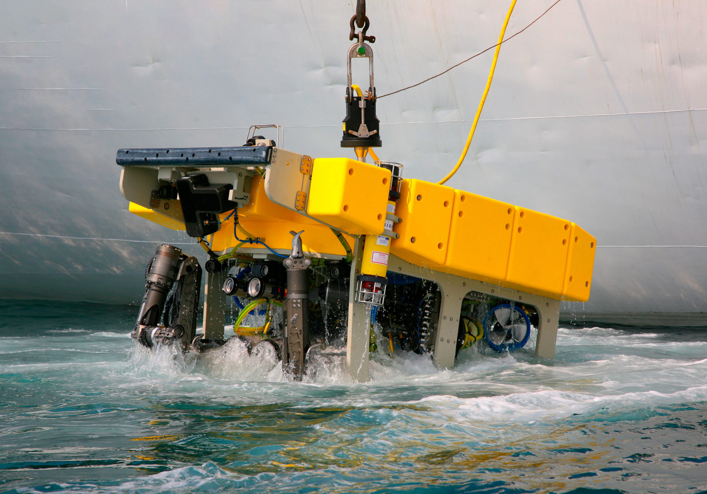 Remotely operated underwater vehicle being lifted out of the water