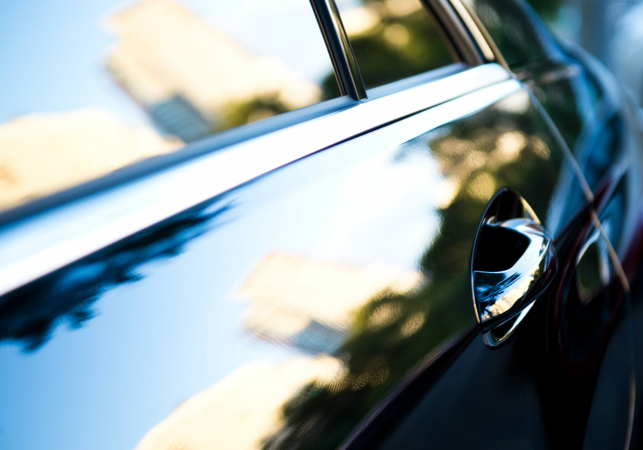 The,Sunset,Is,Reflected,In,The,Brand,New,Car Sunset reflected in close up of car door
