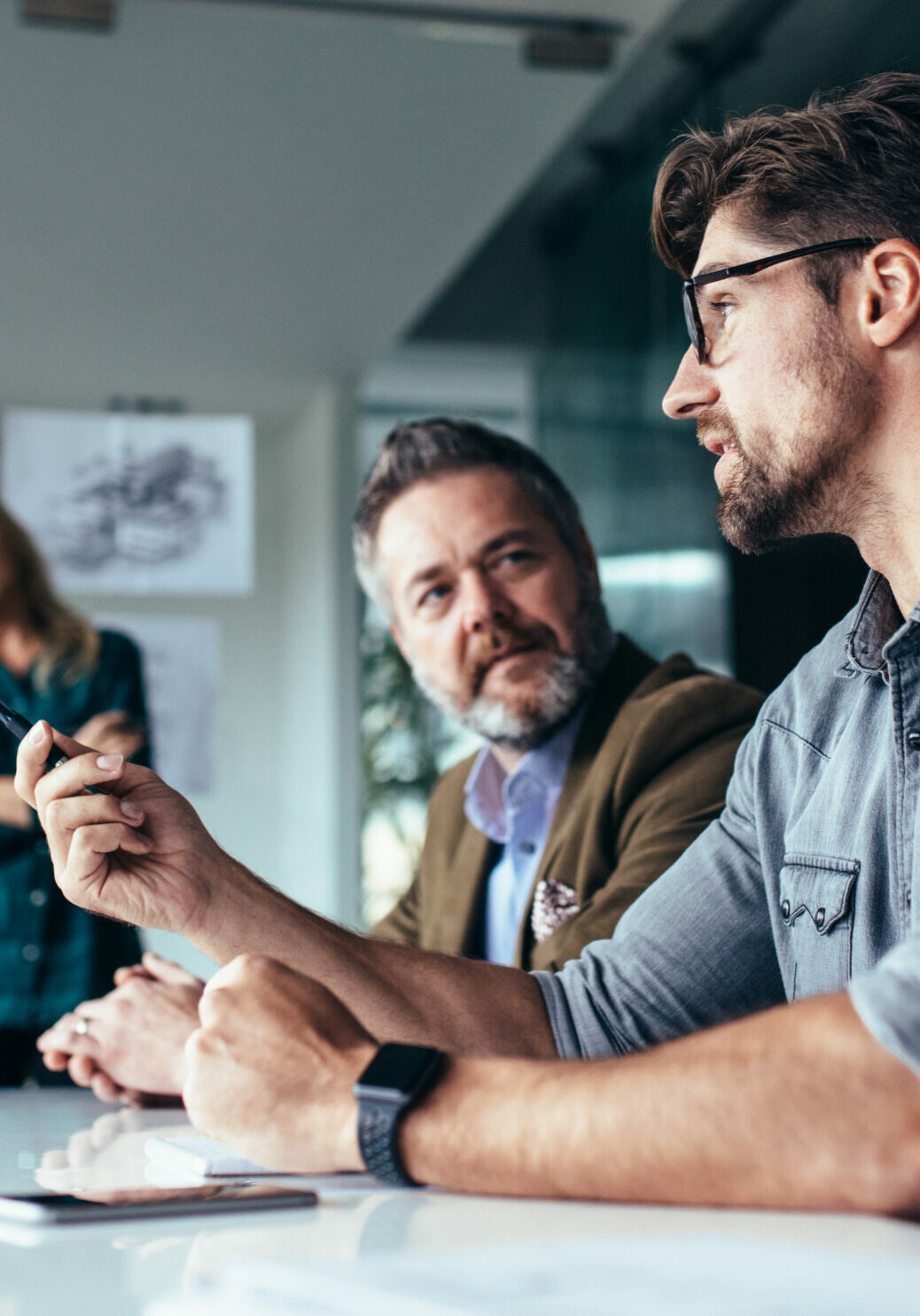 Designer pitching ideas to a group of people in a meeting room